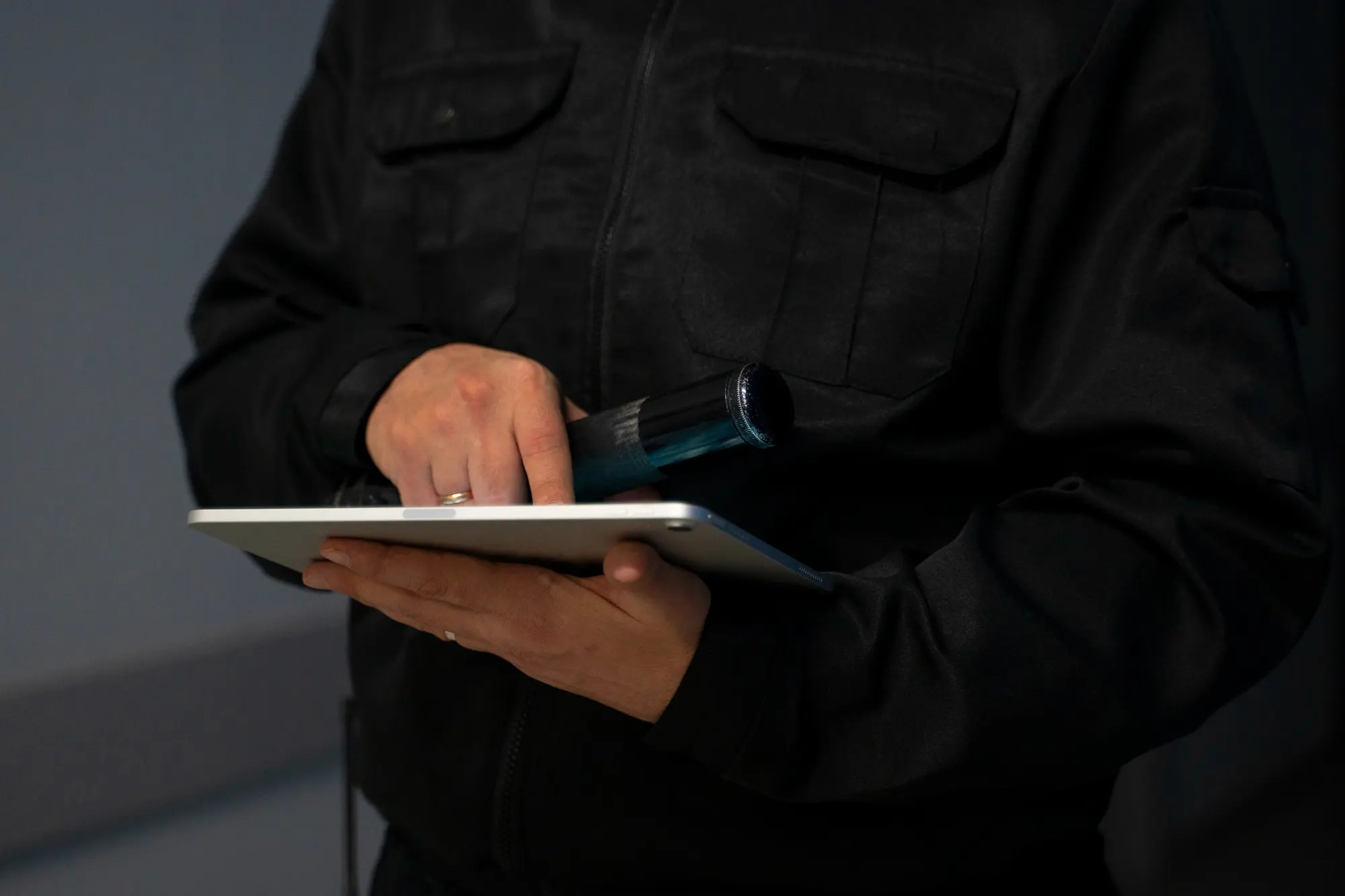 Security officer in uniform checking a tablet